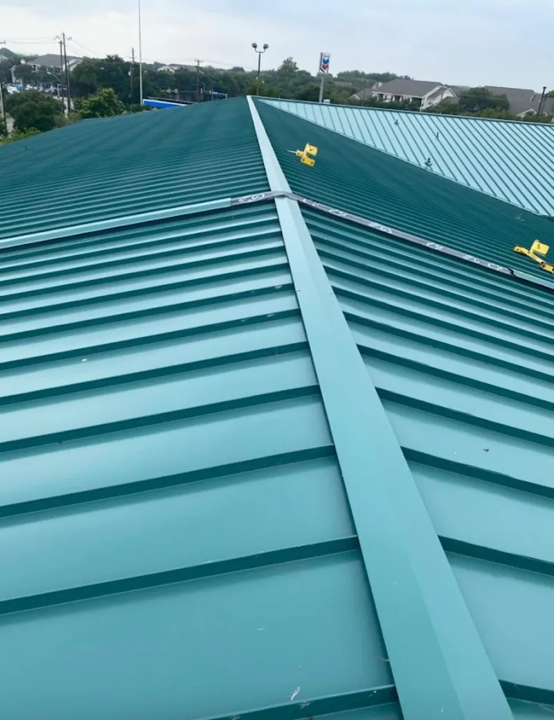 Green commercial metal roof ridge and valley for Metal Roof Repair in Champlin
